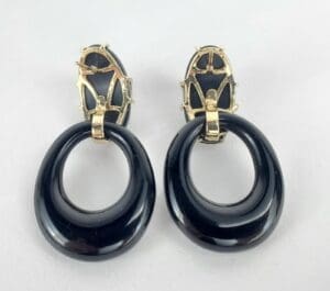 Black and gold oval hoop earrings.