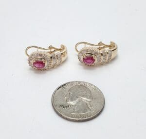 Gold earrings with pink stones, quarter.