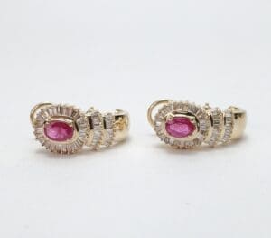 Gold earrings with pink gemstones.