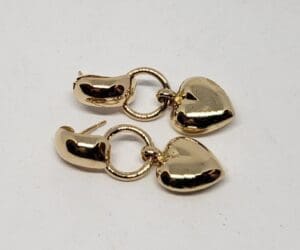 Gold heart-shaped hoop earrings on display.