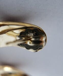 Gold clip with "MK" engraved inside.