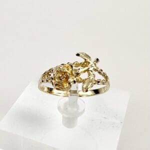 Gold ring with intricate floral design.
