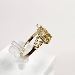 Gold ring with a yellow gemstone.