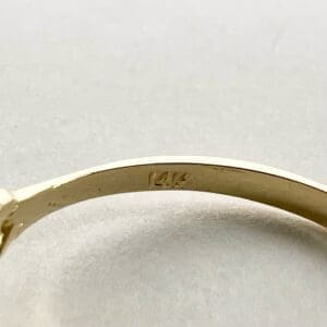 Gold ring with "14K" hallmark stamp.