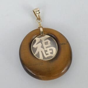 Brown pendant with gold Chinese character.