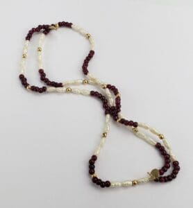 Red and white beaded necklace on display.