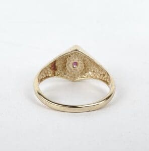 Gold ring with intricate inner design.