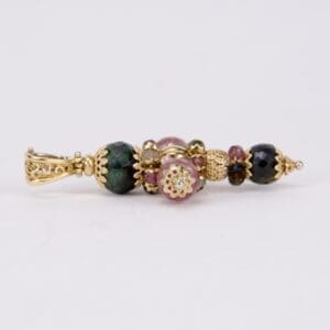 Ornate bead pendant with gold accents.