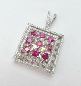 Square pendant with pink and white stones.