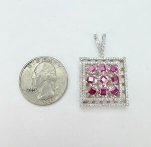 Square pendant with pink gems, quarter coin.