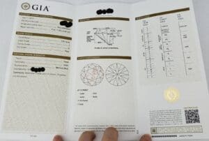GIA diamond grading report held by hand.