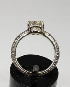 Diamond ring on black display stand.