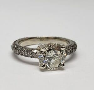Diamond engagement ring with pavé band.