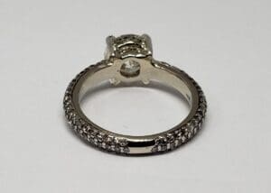 Diamond-studded silver ring on white background.