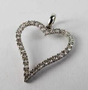 Diamond heart-shaped pendant on white background.