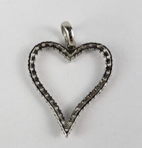 Silver heart-shaped pendant on white background.