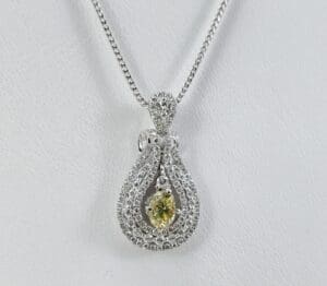 Diamond necklace with yellow gemstone pendant.
