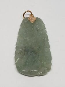 Green jade pendant with gold loop.