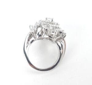 Silver ring with multiple square gemstones.