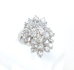 Diamond cluster ring on display stand.