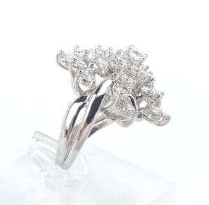 Silver ring with intricate diamond cluster design.