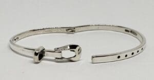 Silver bracelet with unique clasp design.