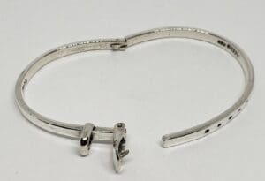 Silver bracelet with unique clasp design.