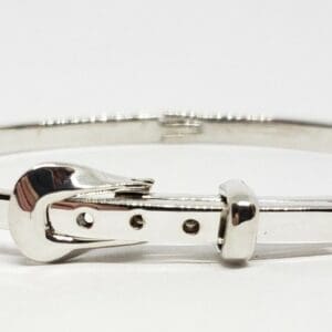 Silver bracelet with buckle design.