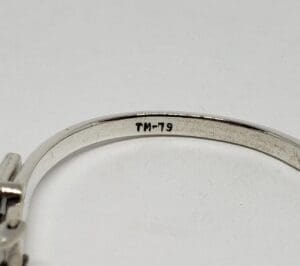 Silver bracelet with "TM-79" inscription inside.