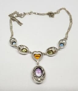 Silver necklace with colorful gemstone pendants.
