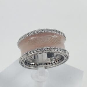 Silver band with pink enamel and diamonds.