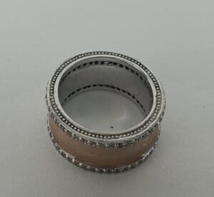Silver and beige decorative napkin ring.