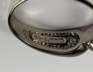 Close-up of a silver ring inscription.