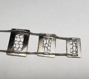 Silver bracelet with geometric rectangular design.