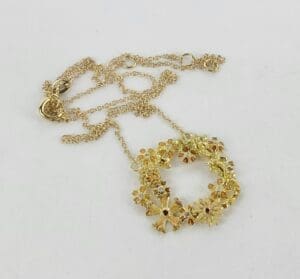 Gold floral necklace with intricate design.
