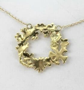 Gold wreath pendant on a delicate chain.