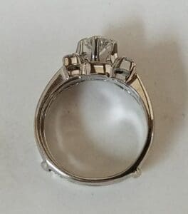 Silver ring with three diamond settings.