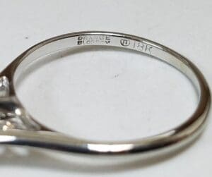 18K gold ring with engraved markings.