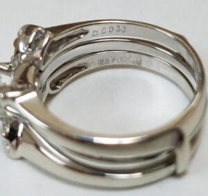 Silver ring with engraved markings, close-up view.