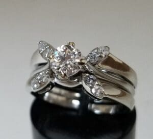 Silver engagement ring with diamond accents.
