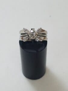 Silver ring with diamond butterfly design.