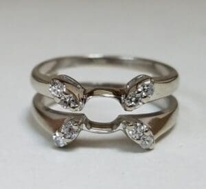 Silver rings with small diamond accents.