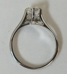 Silver engagement ring with intricate design.