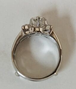 Silver ring with diamond, side view.