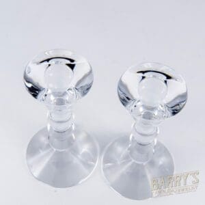 Two clear glass candle holders displayed.