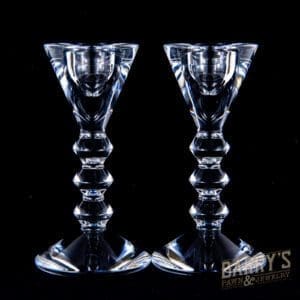 Two crystal candlesticks on black background.