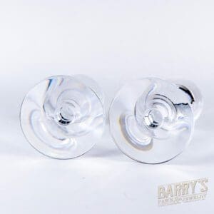 Two clear glass candlestick holders, top view.
