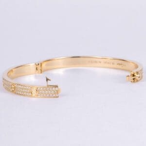 Gold bracelet with diamond accents.