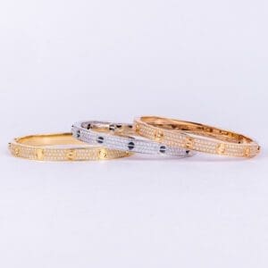 Three jeweled, metallic bracelets on display.