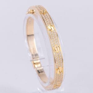 Gold bracelet with diamond accents on display.
